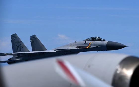 A close up of a fighter jet flying in the air.
