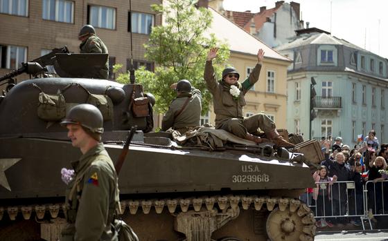 World War II reenactors wave from a tank to crowds during the parade May 4, 2025, at the Pilsen Liberation Festival in Pilsen, Czech Republic, commemorating the 80th anniversary of the city's World War II liberation.