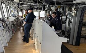 Crew members work aboard a ship.