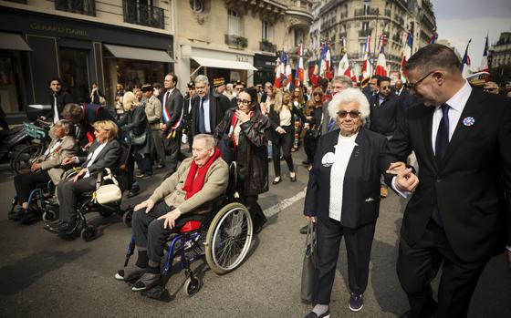 From the left, holocaust survivors Ginette Kolinka, Arlette Testyler, Jacques Altmann, and Ester Senot walk during the commemoration of the 80th anniversary of the return of the deportees, in Paris, France, Sunday, April 27, 2025. (AP Photo/Thomas Padilla)