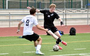Ramstein striker Joseph Yost looks to dink Stuttgart centerback Christian Groves during a May 3, 2025, match at Ramstein High School on Ramstein Air Base, Germany.